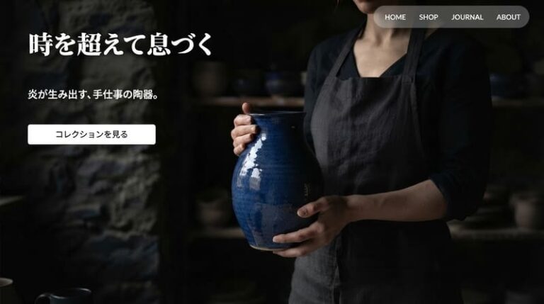 暗い工房の背景の前に光の当たる青い陶器を配置し、主役をクッキリと浮かび上がらせたECサイトのファーストビュー。「時を超えて息づく」「炎が生み出す、手仕事の陶器。」のキャッチコピーが書かれている。